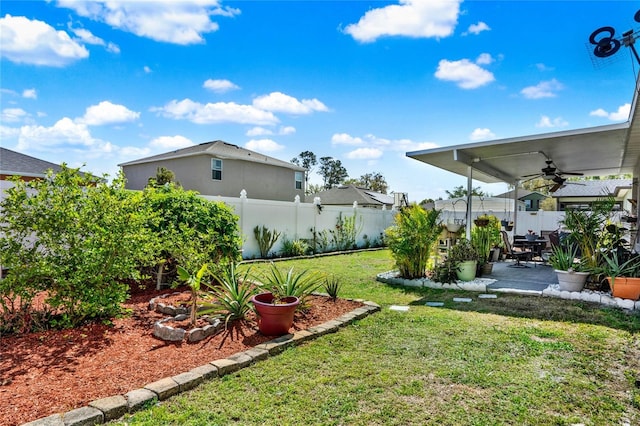 view of yard with ceiling fan, a fenced backyard, and a patio