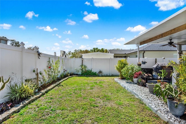 view of yard featuring a ceiling fan and a fenced backyard