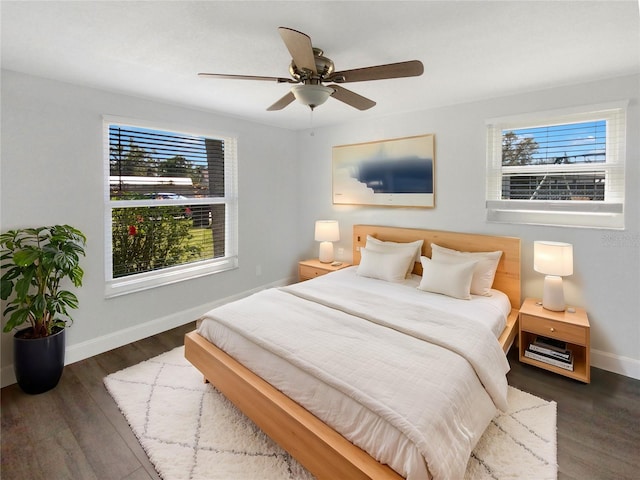 bedroom featuring ceiling fan, wood finished floors, and baseboards