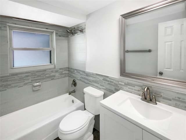 full bathroom featuring toilet, vanity, tile walls, and shower / bathing tub combination