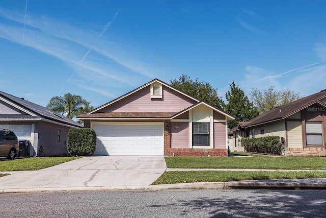 view of front facade with a garage, a front yard, concrete driveway, and brick siding