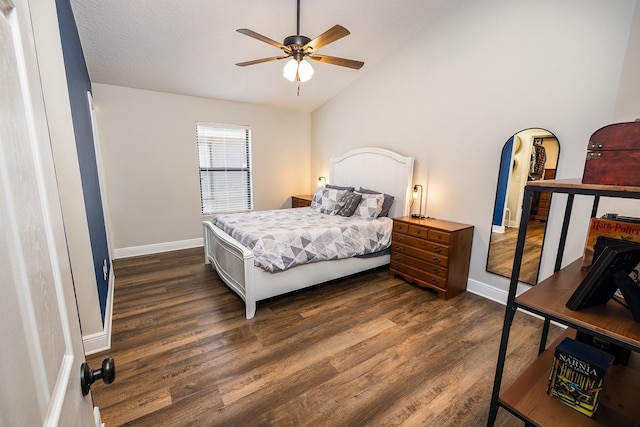 bedroom featuring lofted ceiling, dark wood-style flooring, ceiling fan, and baseboards