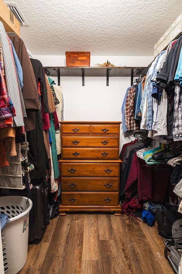 walk in closet featuring dark wood-type flooring and visible vents