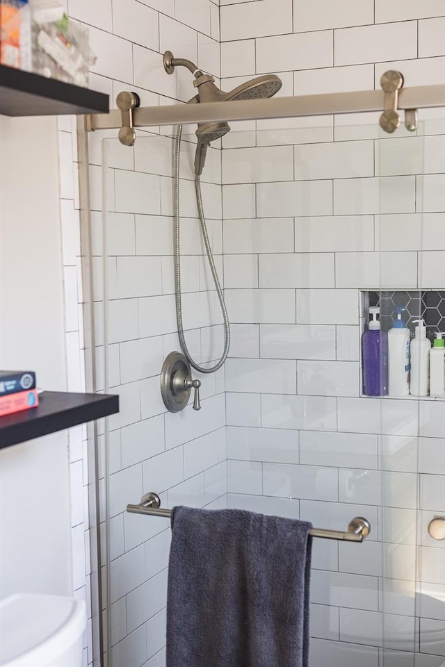 full bath with a tile shower