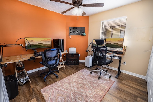 office space featuring a ceiling fan, baseboards, and wood finished floors