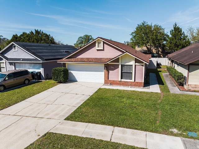 view of front of home with a garage, brick siding, fence, concrete driveway, and a front yard