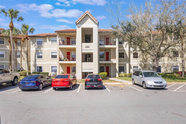 view of building exterior with uncovered parking