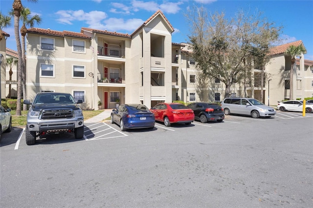 view of building exterior with uncovered parking