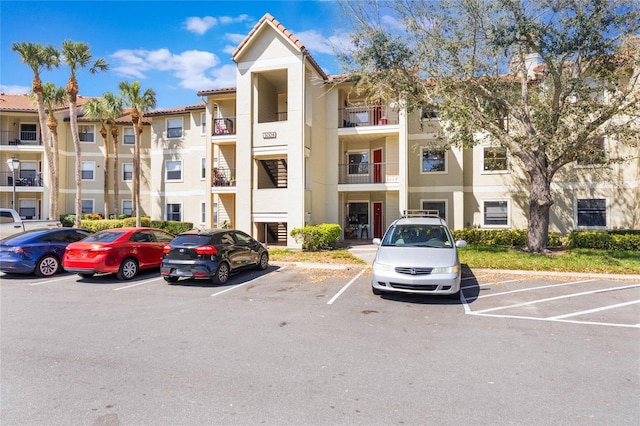 view of building exterior with uncovered parking