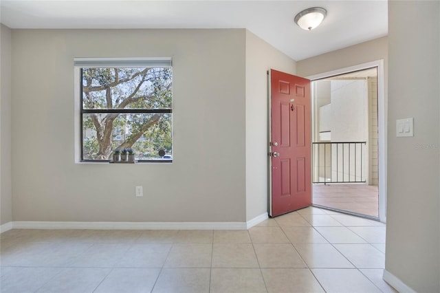 entryway with light tile patterned floors and baseboards