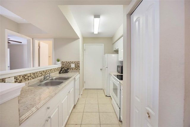 kitchen featuring white appliances, a sink, white cabinetry, light countertops, and tasteful backsplash