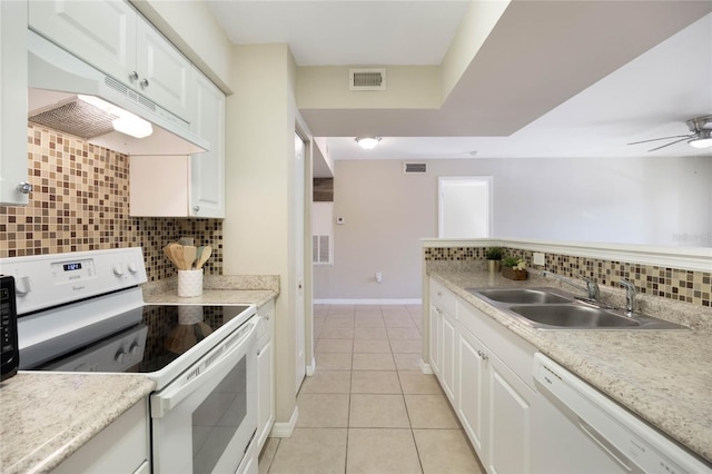 kitchen featuring white appliances, visible vents, a sink, and under cabinet range hood