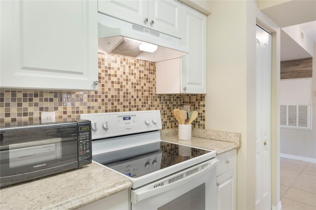 kitchen with white range with electric stovetop, visible vents, backsplash, white cabinets, and under cabinet range hood