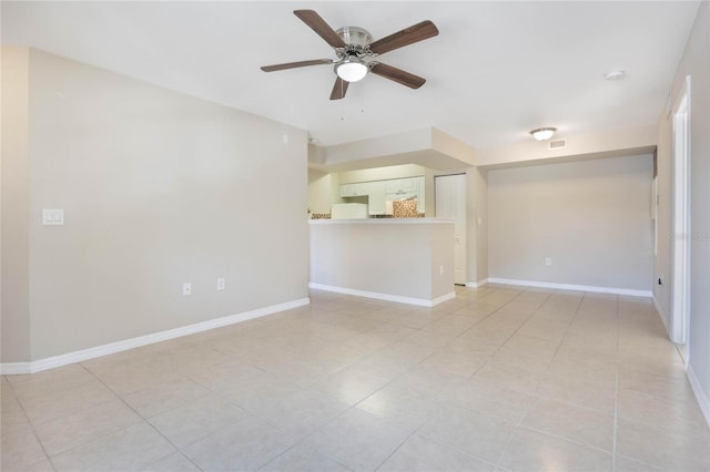 unfurnished room with visible vents, ceiling fan, baseboards, and light tile patterned floors