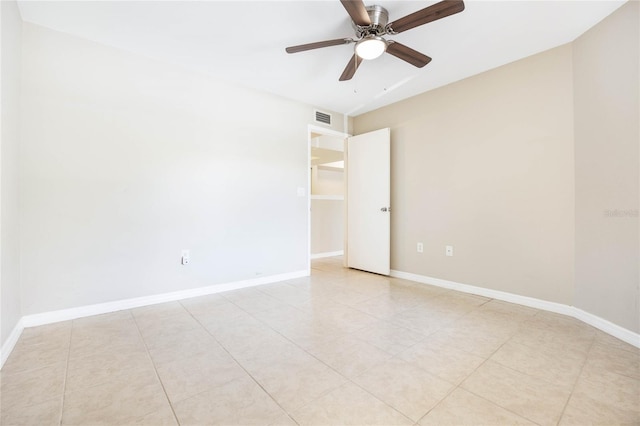 unfurnished room featuring baseboards, visible vents, and a ceiling fan