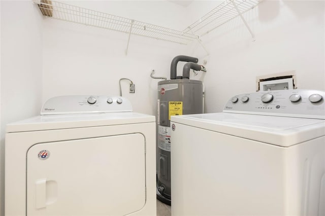 laundry room featuring laundry area, independent washer and dryer, and electric water heater