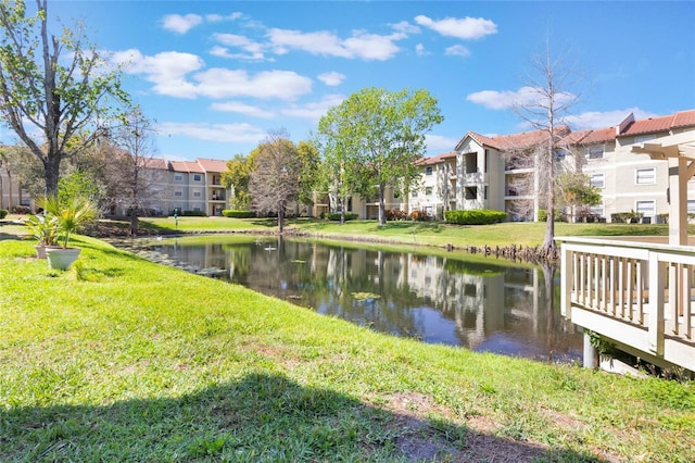 view of community featuring a yard, a water view, and a residential view