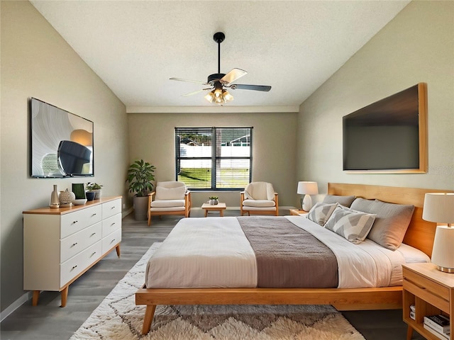 bedroom with lofted ceiling, ceiling fan, wood finished floors, and baseboards