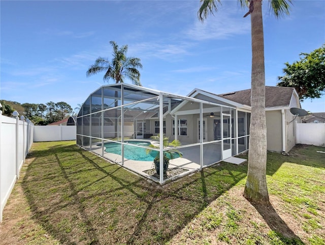 view of swimming pool with a yard, a fenced backyard, a ceiling fan, and a fenced in pool