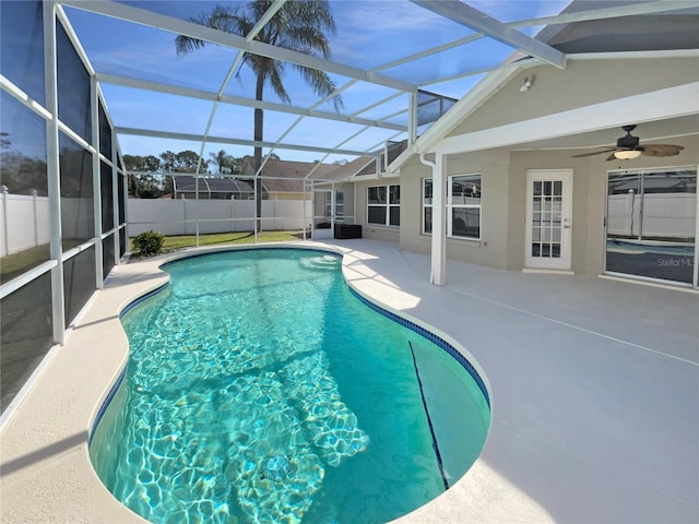 view of swimming pool with a fenced in pool, a ceiling fan, a lanai, fence private yard, and a patio area