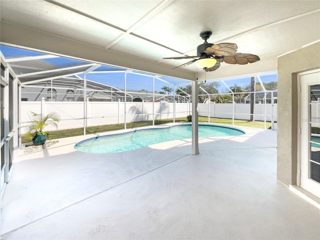 view of swimming pool featuring a fenced in pool, a patio, a fenced backyard, ceiling fan, and a lanai