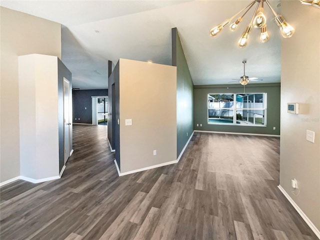 spare room with lofted ceiling, dark wood-style flooring, ceiling fan, and baseboards