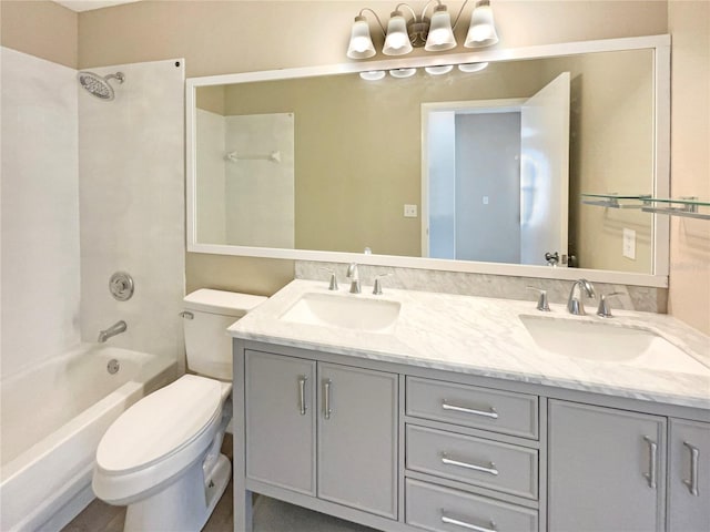 full bathroom with double vanity, bathing tub / shower combination, a sink, and toilet