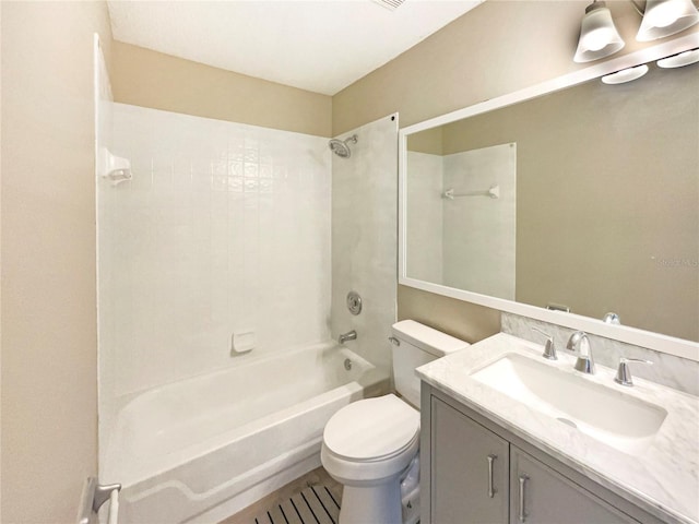 bathroom featuring shower / washtub combination, vanity, and toilet