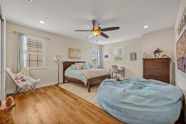 bedroom with a ceiling fan, recessed lighting, light wood-style floors, and baseboards