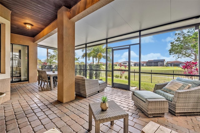 sunroom / solarium featuring wooden ceiling