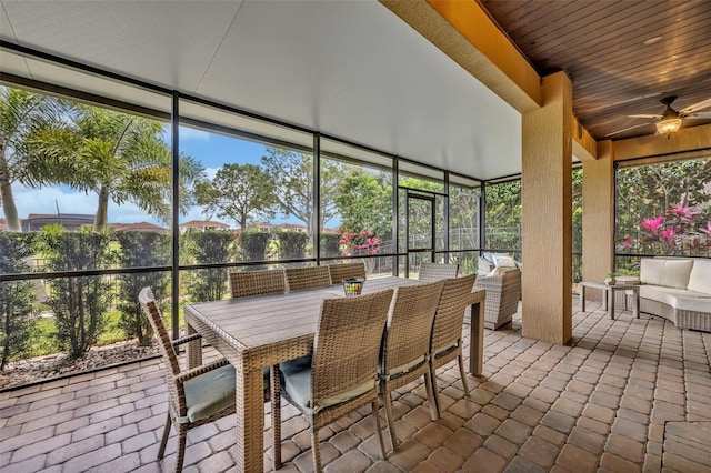 sunroom featuring a ceiling fan