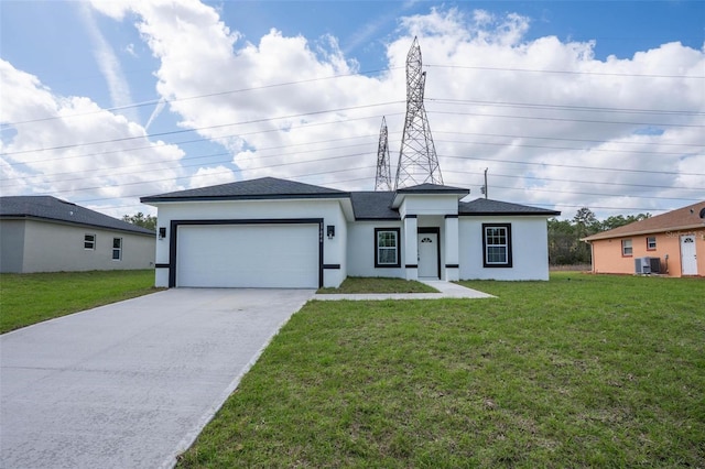 view of front of property with a front yard, driveway, an attached garage, and stucco siding