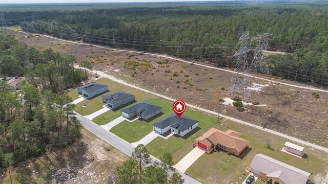 drone / aerial view featuring a forest view