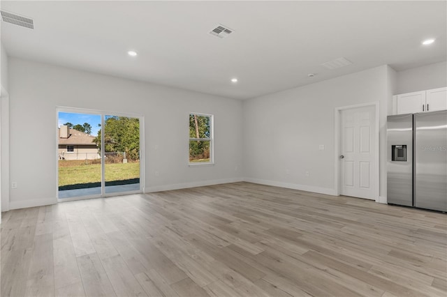 unfurnished living room featuring recessed lighting, visible vents, and light wood-style flooring