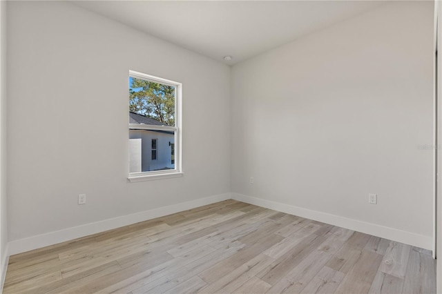 unfurnished room featuring light wood-type flooring and baseboards