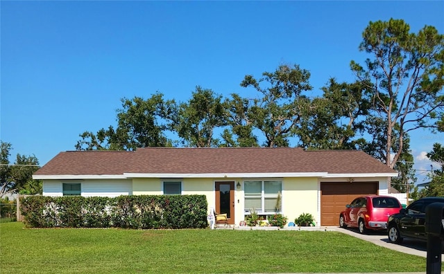 ranch-style house with a garage, driveway, a front yard, and stucco siding