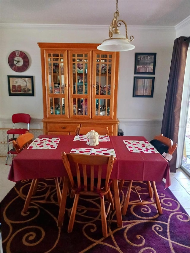 dining space featuring ornamental molding and light tile patterned flooring