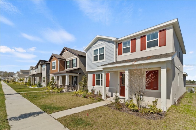 view of property with a front yard, a residential view, and stucco siding