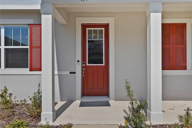 view of exterior entry with stucco siding