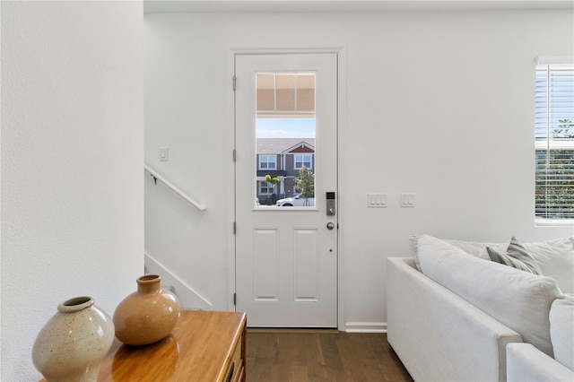 entryway with dark wood finished floors and stairway