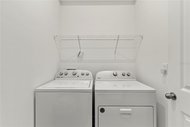 washroom featuring laundry area and washer and clothes dryer