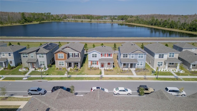 drone / aerial view featuring a residential view and a water view