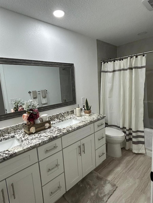 bathroom with double vanity, visible vents, and a sink