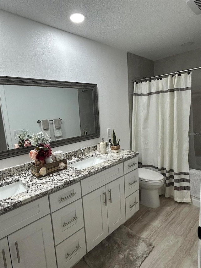 full bathroom with double vanity, a sink, and visible vents