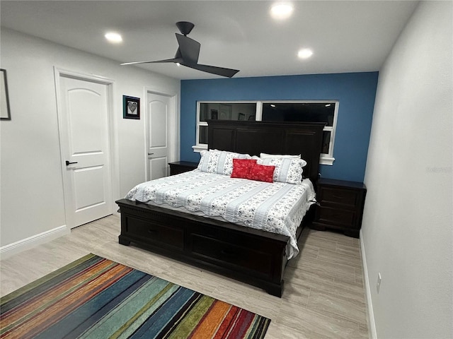 bedroom with light wood-type flooring, ceiling fan, baseboards, and recessed lighting