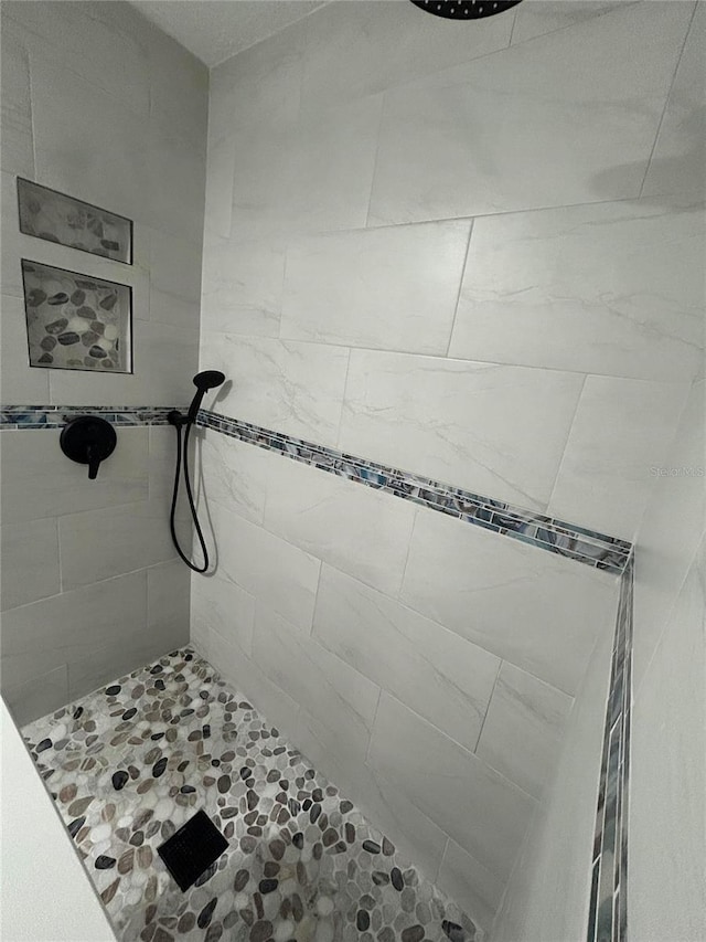 bathroom with a tile shower