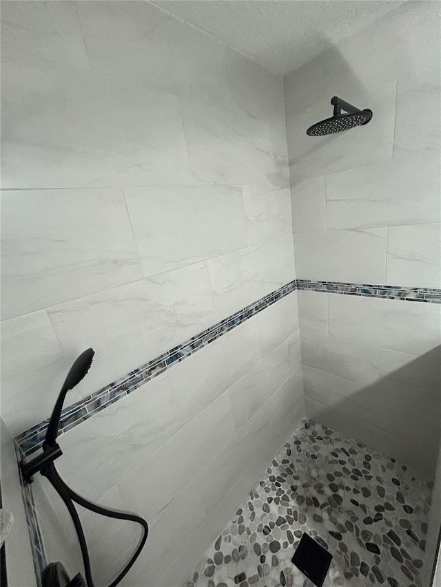 bathroom with a tile shower