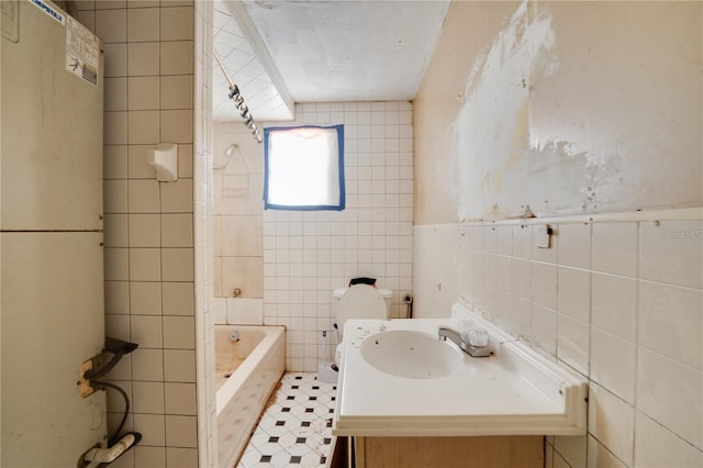 bathroom featuring  shower combination, tile patterned flooring, tile walls, and vanity