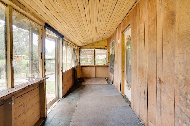 unfurnished sunroom with lofted ceiling and wooden ceiling