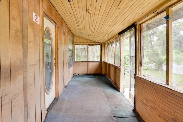 unfurnished sunroom featuring vaulted ceiling and wooden ceiling